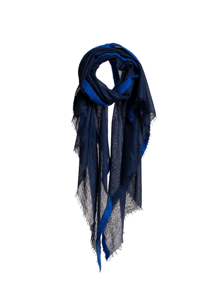 A dark blue and navy sheer scarf with fringed edges, styled in a loose loop against a light gray background.