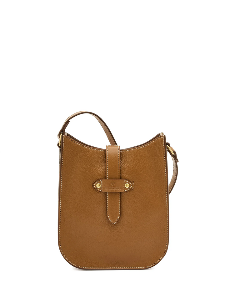 A tan leather bag with a front strap closure and gold-tone hardware, photographed against a solid white background.