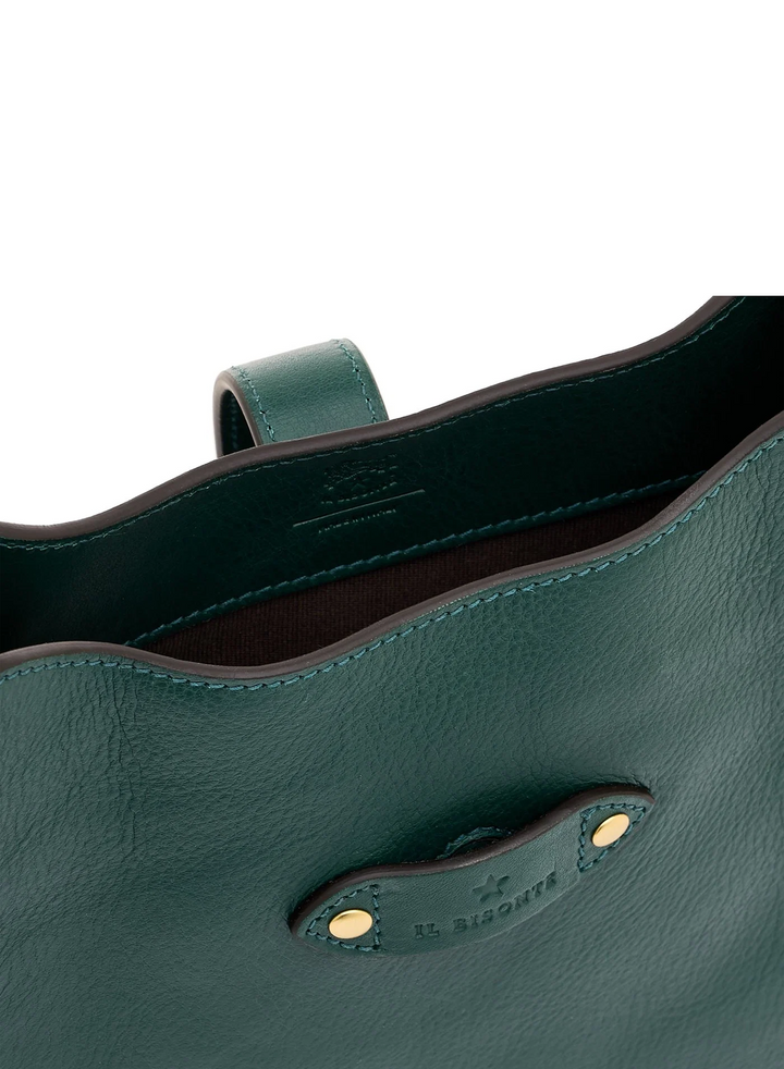 Close-up of a dark green pebbled leather tote bag showing the interior lining, stitched rim, and a leather handle with gold-tone rivets and an embossed logo.