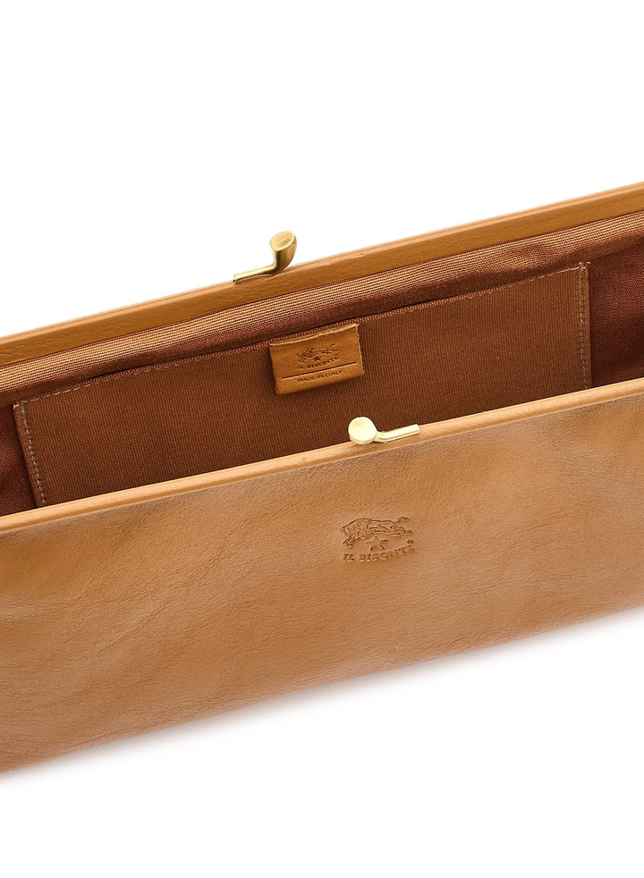 Close-up of a tan leather clutch or case interior with a brown fabric lining, gold-tone frame hardware, and an embossed logo on the front.