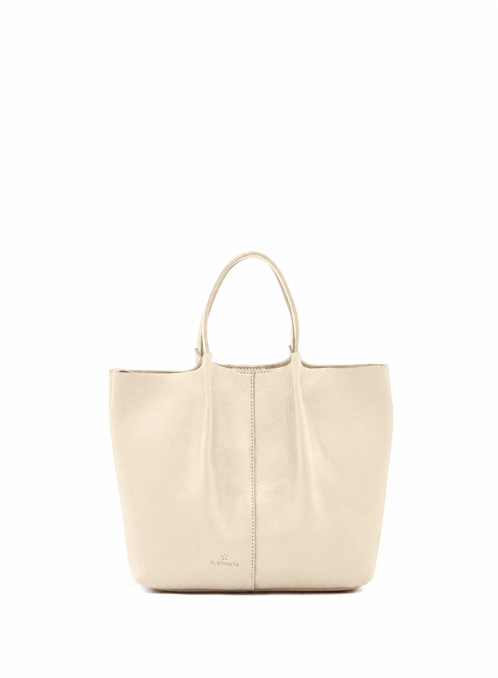 A light beige leather tote bag with double top handles and a subtle embossed logo near the bottom center, shown against a plain white background.