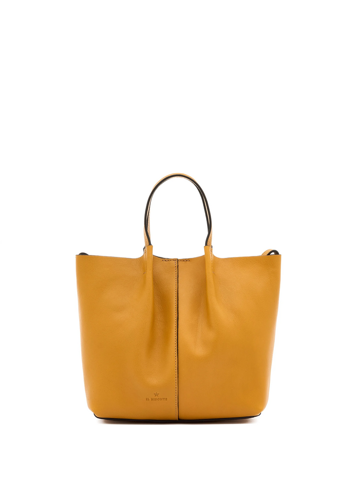 A mustard yellow leather tote bag with double top handles and a central vertical seam, photographed against a solid white background.