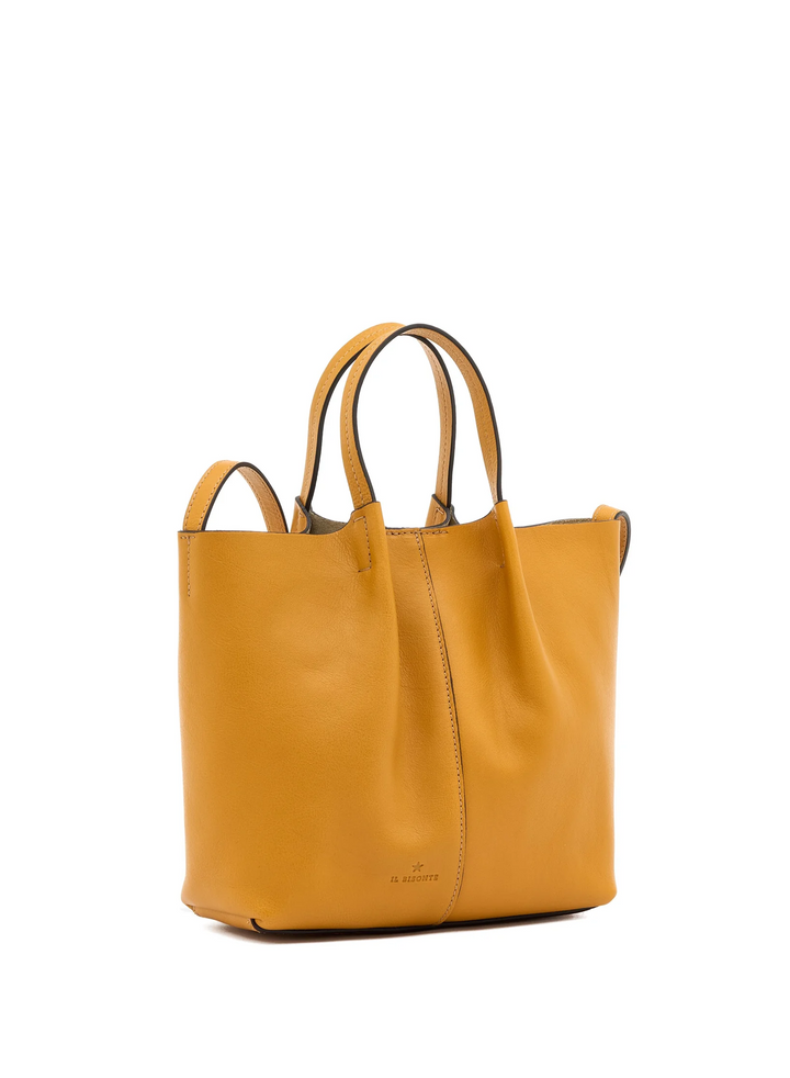 A mustard yellow leather tote bag with dual top handles, shown from a three-quarter angle against a plain white background.